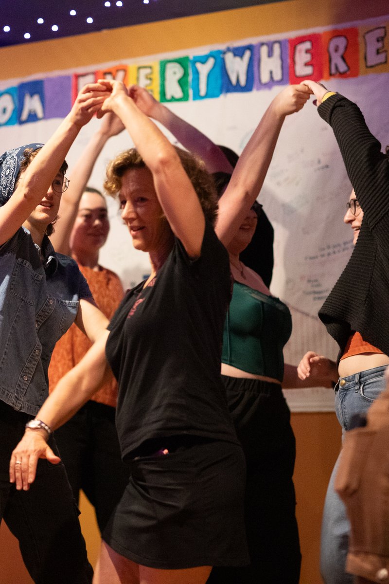 Several community members participate in a salsa dance workshop.