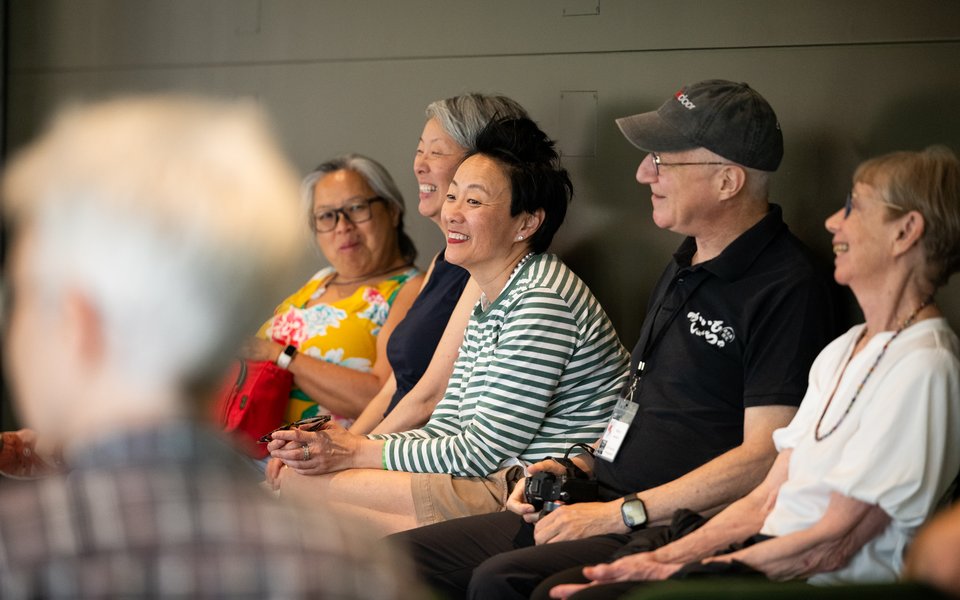 Patrons sitting and smiling at a pre-show talk.