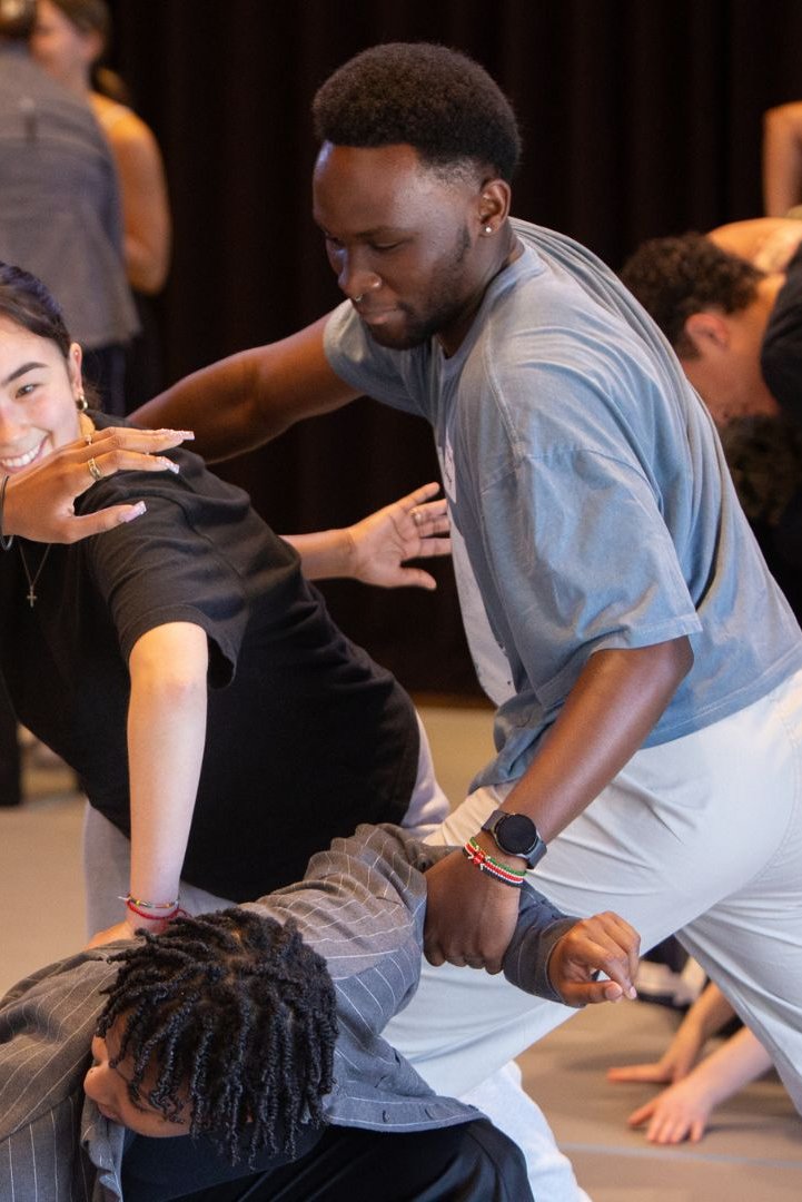 Four College Convening attendees create a shape together in a movement exploration.